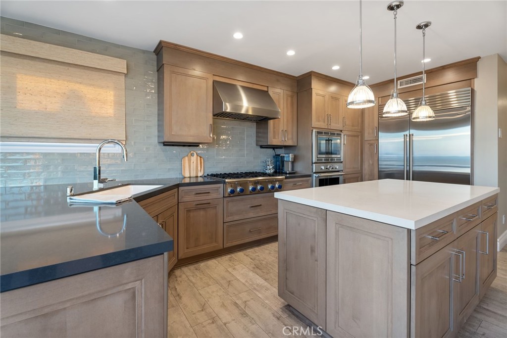 4403 Seashore Drive Newport Beach, CA 92663 - Photo 55 of 69 a kitchen that has a sink a stove and a wooden floor