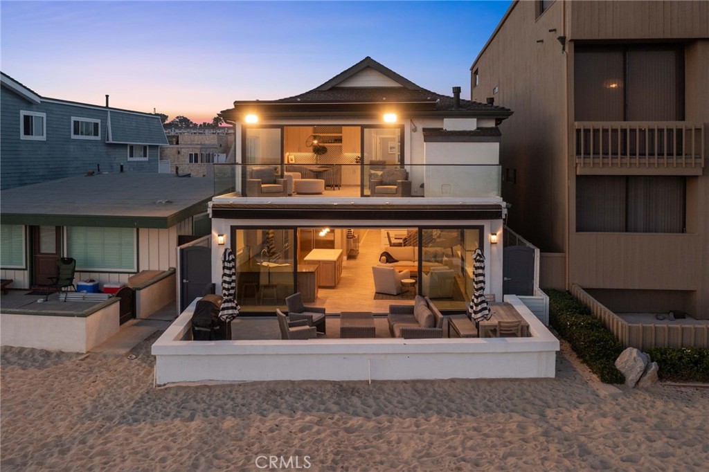 4403 Seashore Drive Newport Beach, CA 92663 - Photo 68 of 69 a view of a house with a large window and couches in the patio