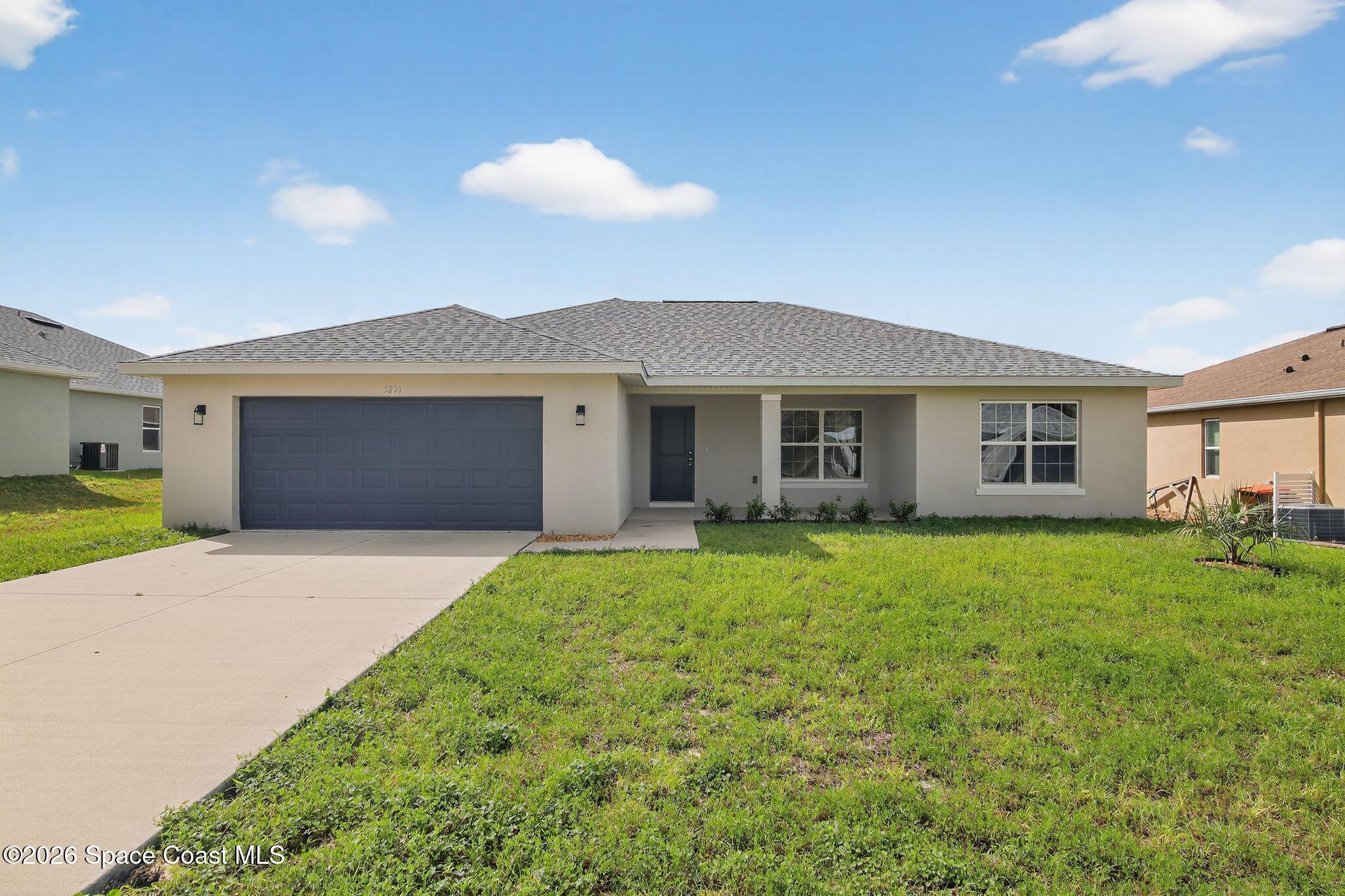 a front view of house with yard and green space