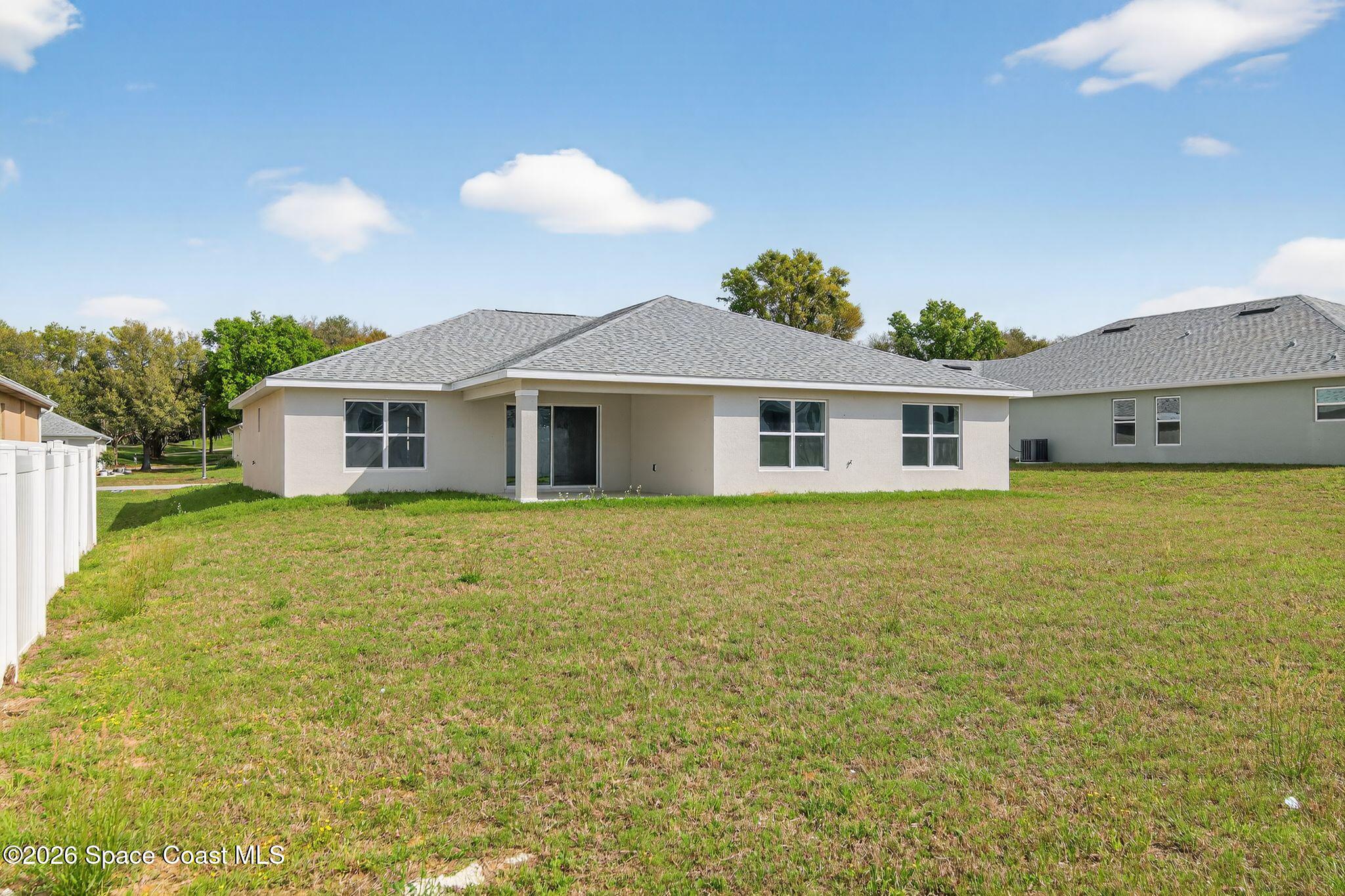 5294 Southeast 91st Street Ocala, FL 34480 - Photo 15 of 15 a view of a house with a backyard