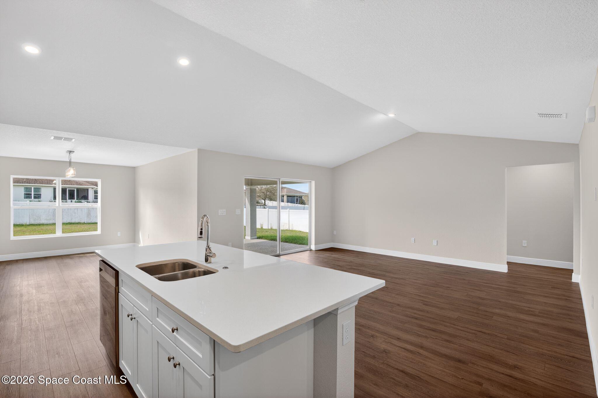 5294 Southeast 91st Street Ocala, FL 34480 - Photo 3 of 15 a kitchen with a stove a sink and wooden floor