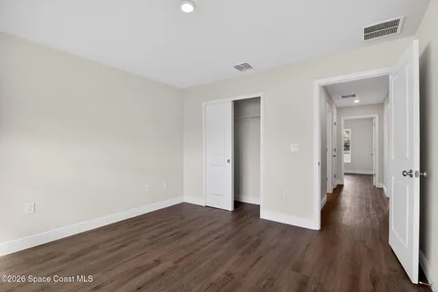 a view of a room with wooden floor and brick walls