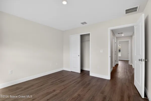 a view of a room with wooden floor and brick walls
