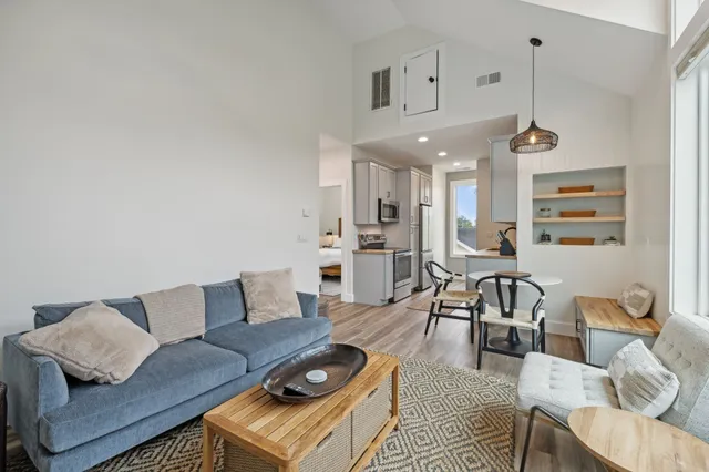 a living room with furniture and kitchen view