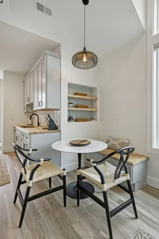 a view of a dining room with furniture and wooden floor