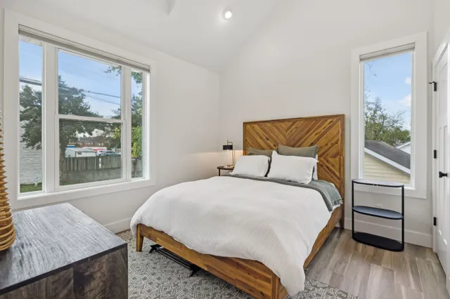 a bedroom with a bed and wooden floor