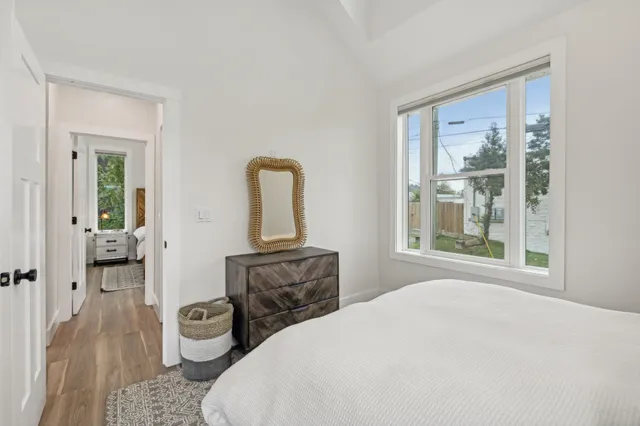 a bedroom with a bed and wooden floor