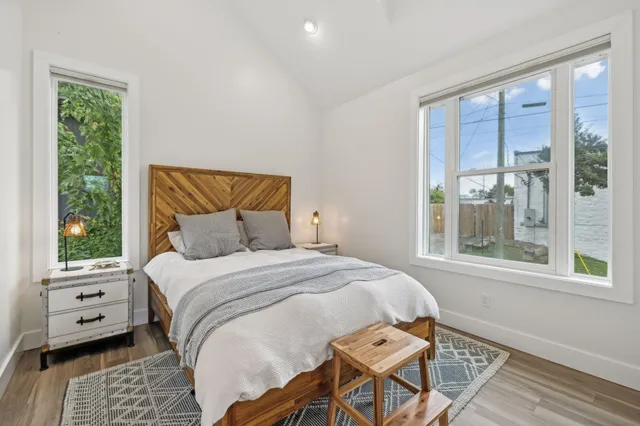 a bedroom with a bed a table and a window