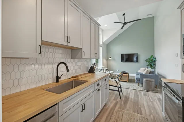 a kitchen with a sink cabinets and wooden floor