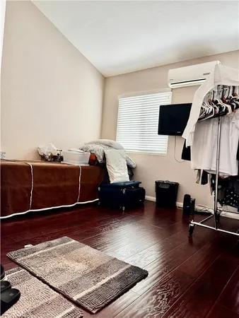 a room with a bed and wooden floor