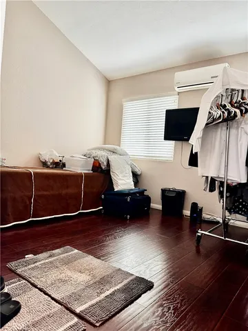 a room with a bed and wooden floor