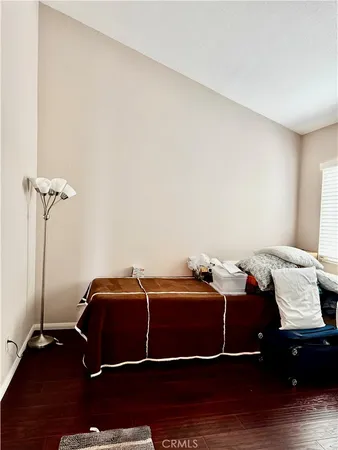 a bedroom with a bed and a mirror