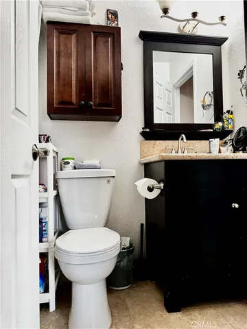 a bedroom with a desk and a window