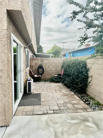 a house with potted plants in front of it