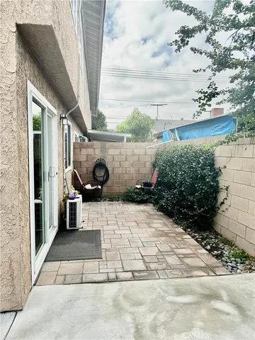 a house with potted plants in front of it
