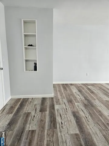 a view of a room with wooden floor