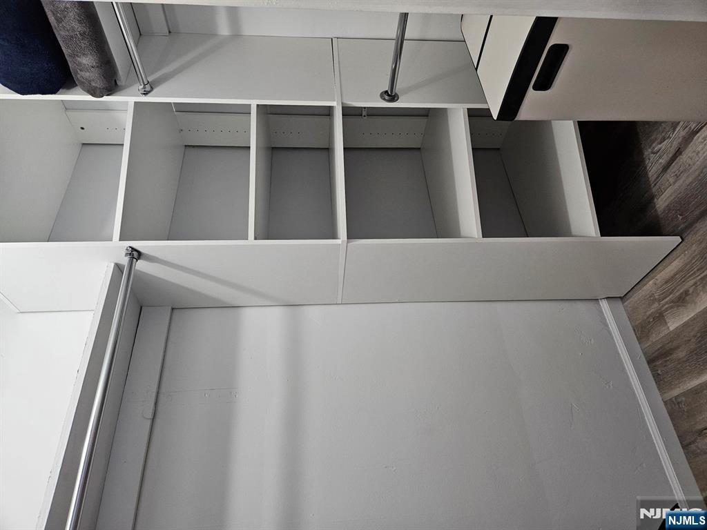 605 Grove Street, Unit F8 Clifton, NJ 07013 - Photo 7 of 15 a view of walk in closet with empty racks