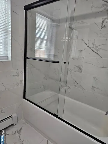 a bathroom with a bathtub and a shower