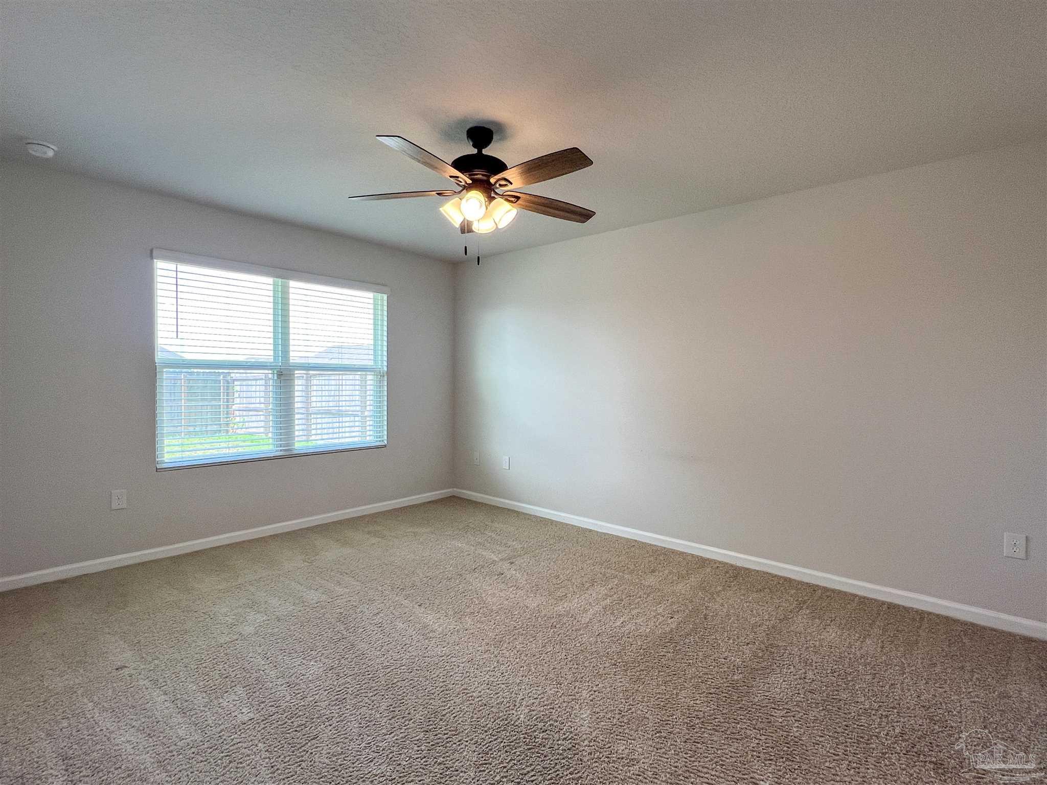 5292 Peach Drive Pace, FL 32571 - Photo 12 of 27 an empty room with windows and fan