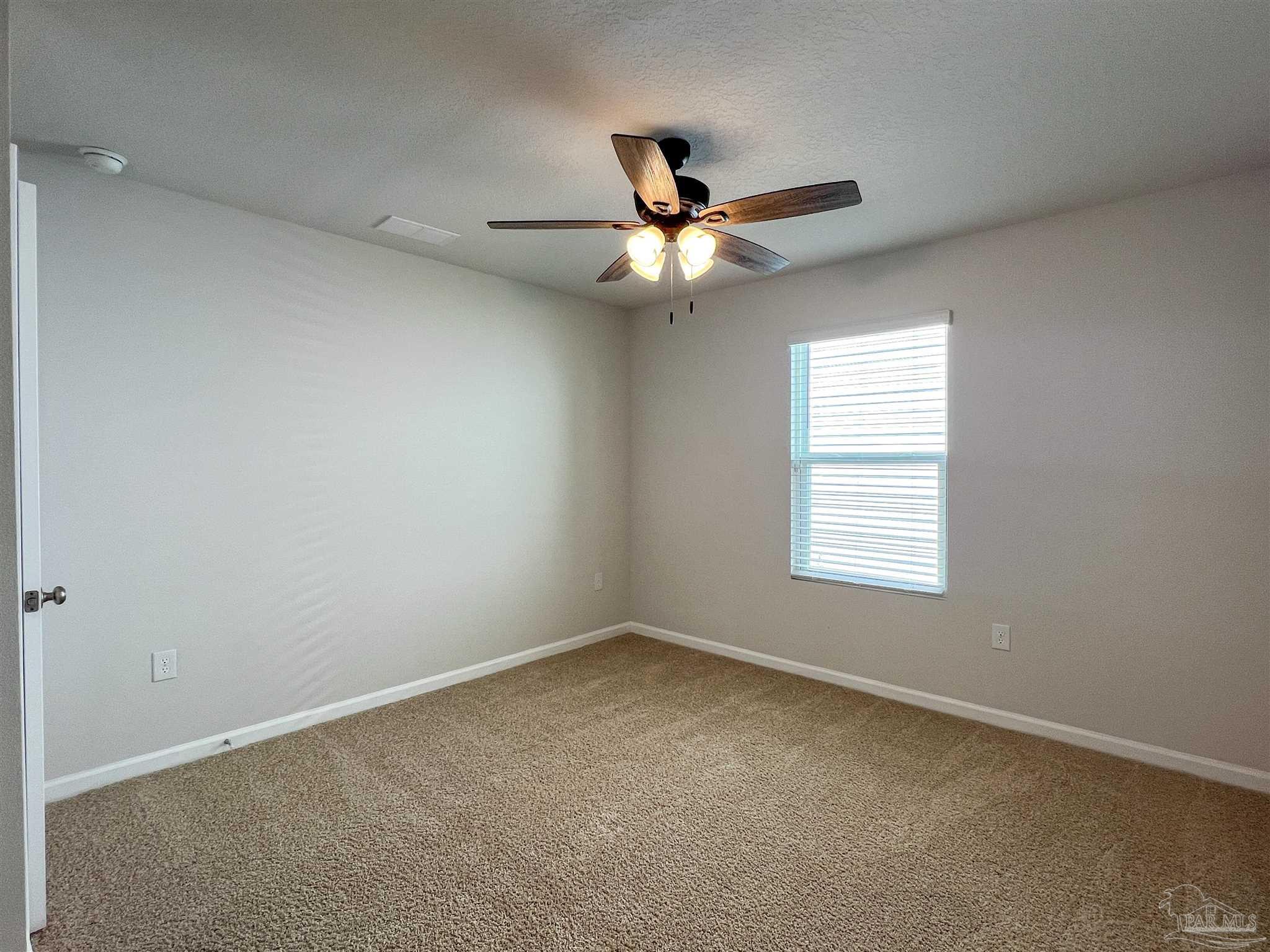 5292 Peach Drive Pace, FL 32571 - Photo 18 of 27 an empty room with a window and a fan