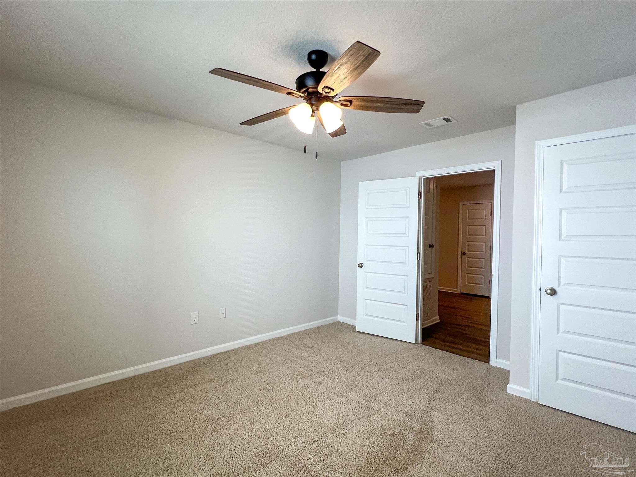 5292 Peach Drive Pace, FL 32571 - Photo 19 of 27 an empty room with closet and a ceiling fan