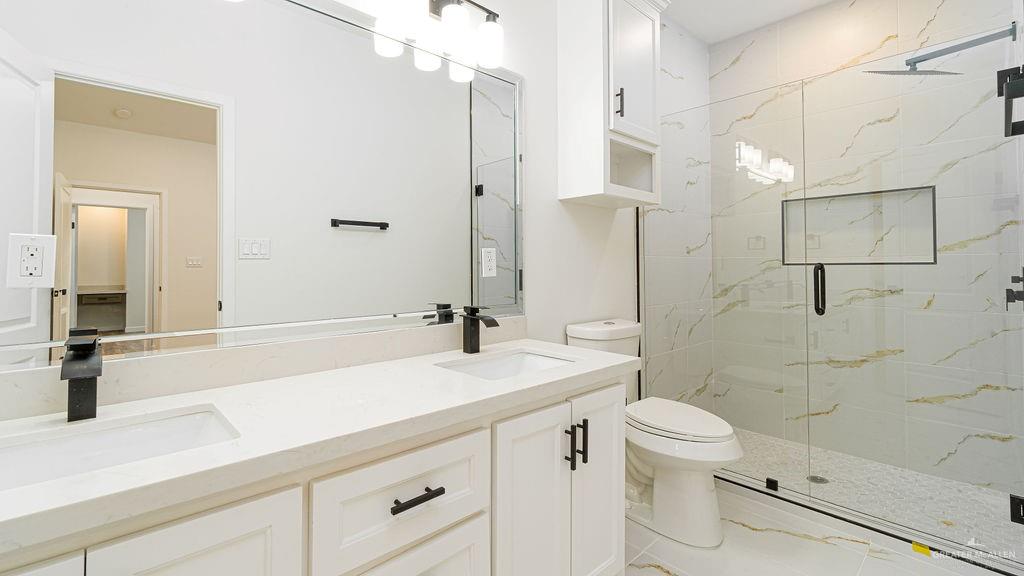 1212 East Acacia Drive East San Juan, TX 78589 - Photo 11 of 16 a bathroom with a sink a toilet and shower