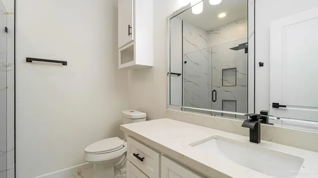 a bathroom with a sink toilet and shower