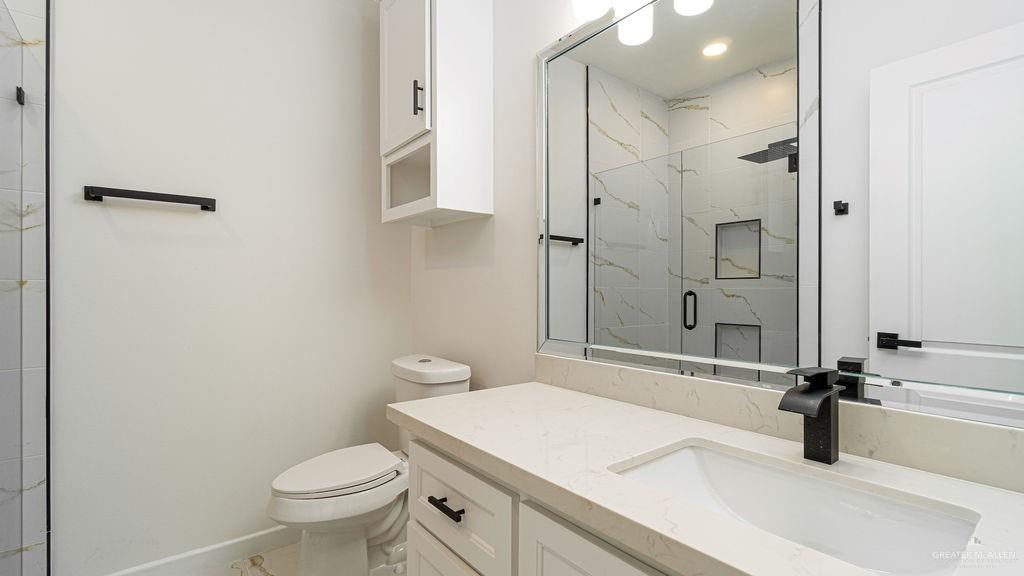 1212 East Acacia Drive East San Juan, TX 78589 - Photo 14 of 16 a bathroom with a sink toilet and shower