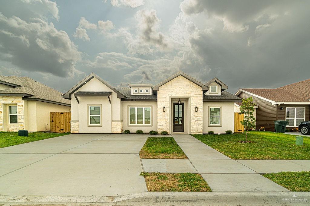 1212 East Acacia Drive East San Juan, TX 78589 - Photo 2 of 16 a view of a white house with a big yard and large trees