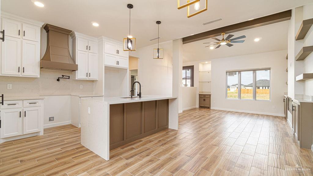 1212 East Acacia Drive East San Juan, TX 78589 - Photo 4 of 16 a kitchen with kitchen island white cabinets and refrigerator