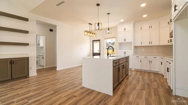 a kitchen with stainless steel appliances granite countertop a white stove top oven and a chandelier
