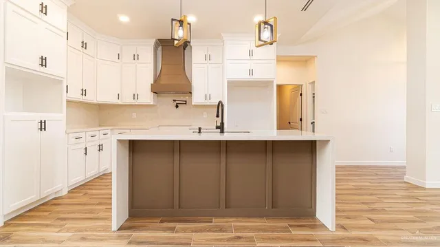 a kitchen with a sink stainless steel appliances and cabinets
