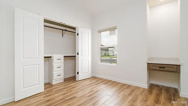 an empty room with windows and closet