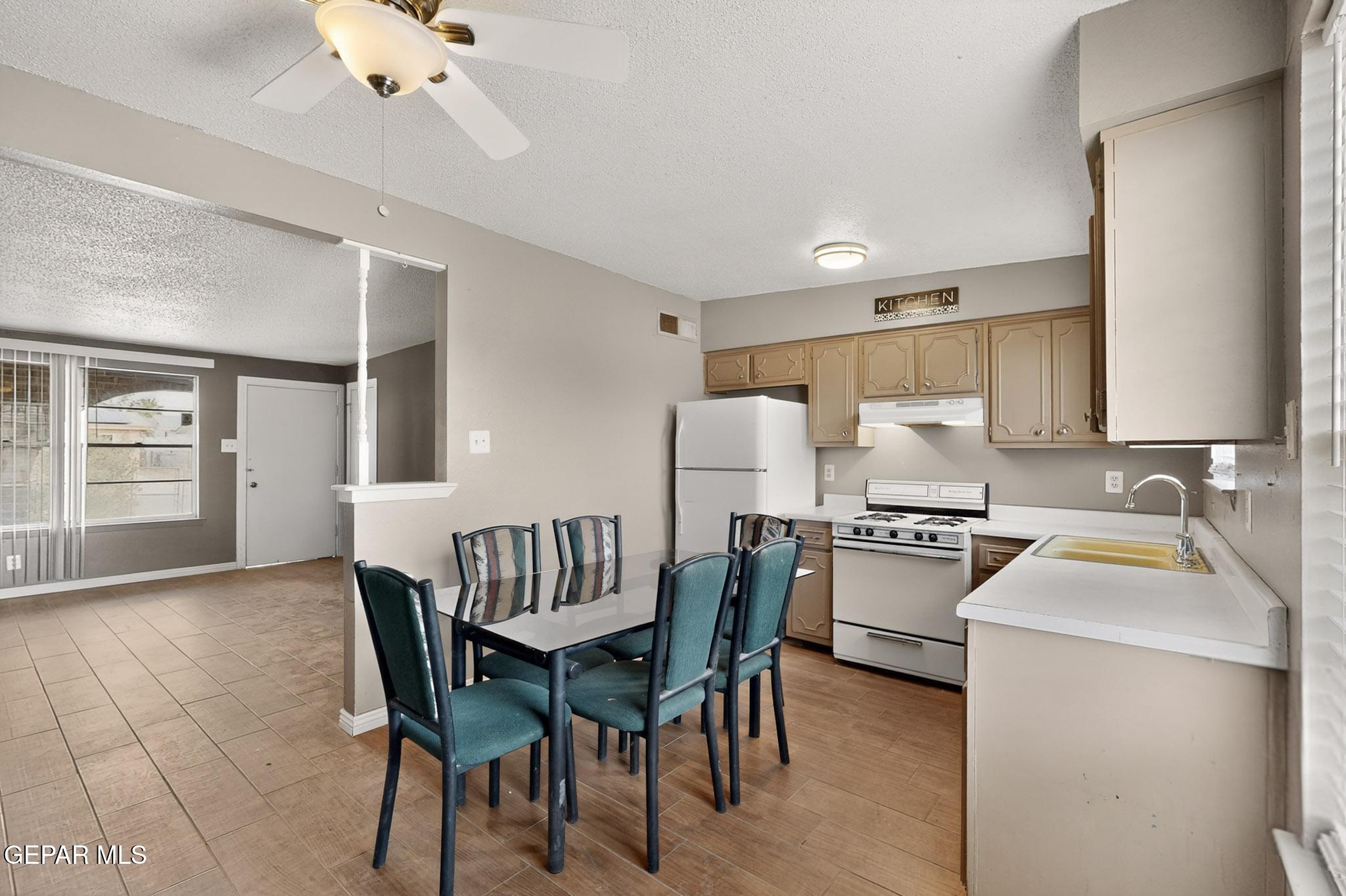 917 Marigold Way El Paso, TX 79907 - Photo 11 of 38 a kitchen with sink a table and chairs