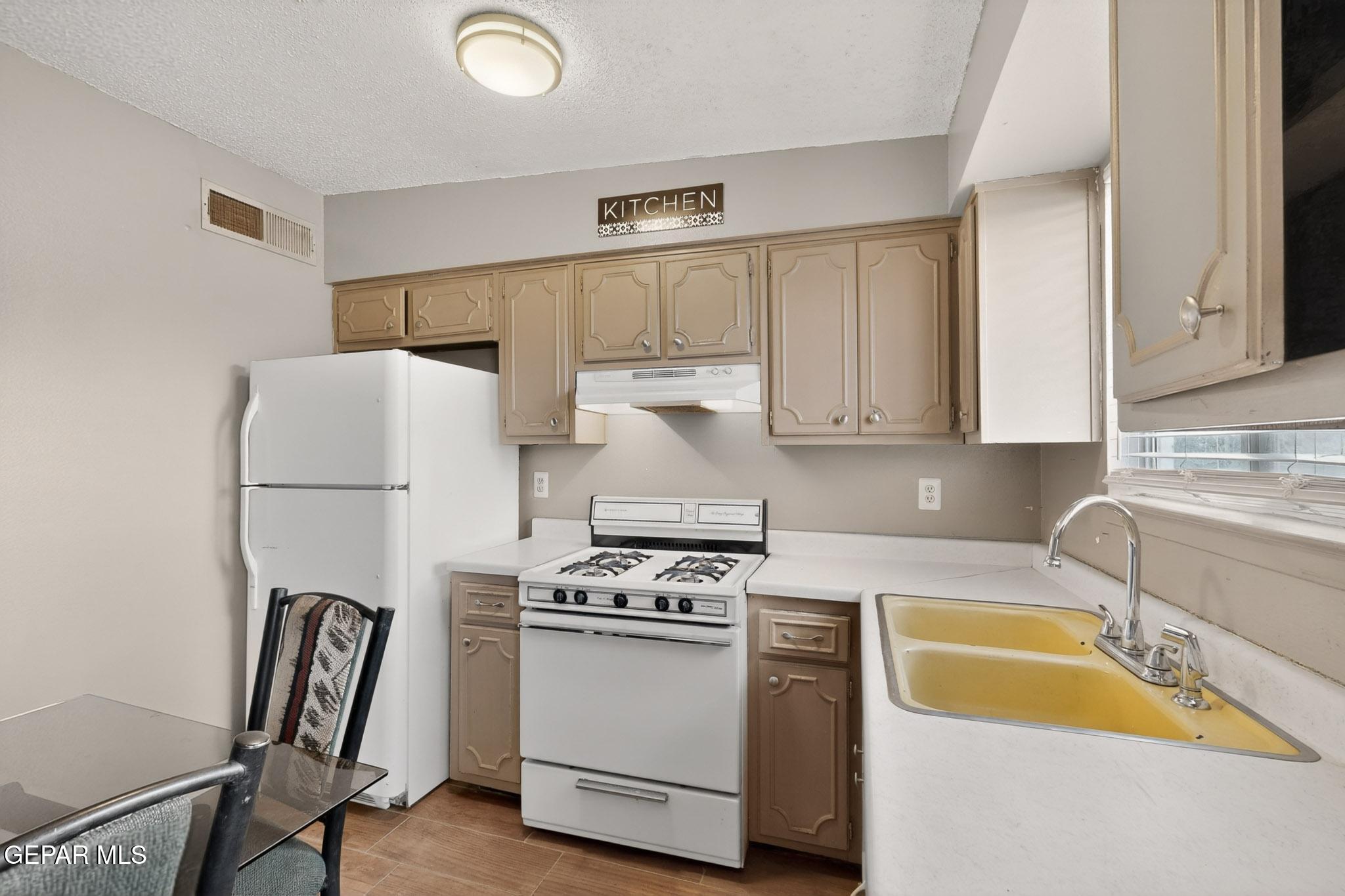 917 Marigold Way El Paso, TX 79907 - Photo 12 of 38 a kitchen with stainless steel appliances granite countertop a sink stove and refrigerator