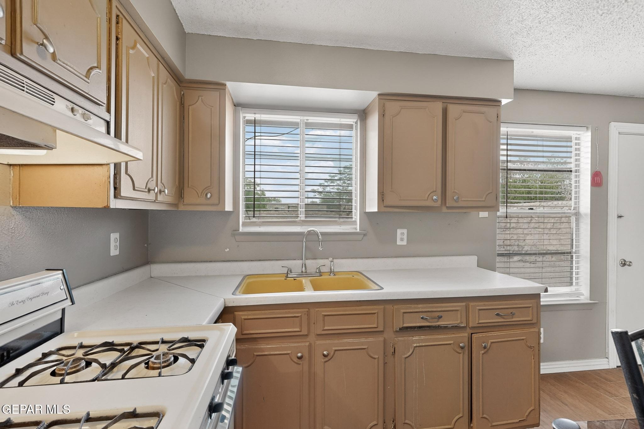 917 Marigold Way El Paso, TX 79907 - Photo 13 of 38 a kitchen that has a sink and a stove