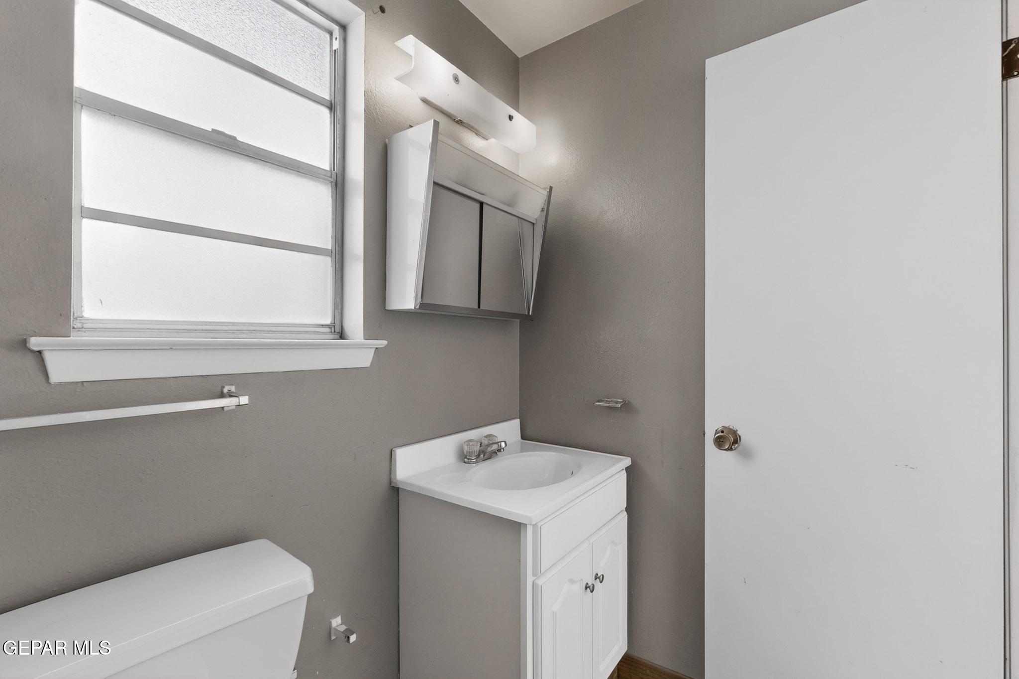 917 Marigold Way El Paso, TX 79907 - Photo 17 of 38 a bathroom with a sink a toilet and a mirror