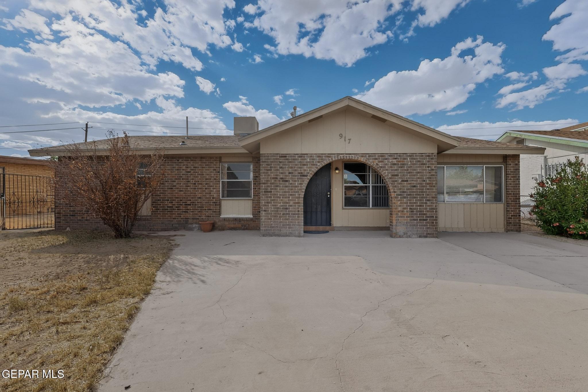 917 Marigold Way El Paso, TX 79907 - Photo 2 of 38 a view of a house with a yard and garage