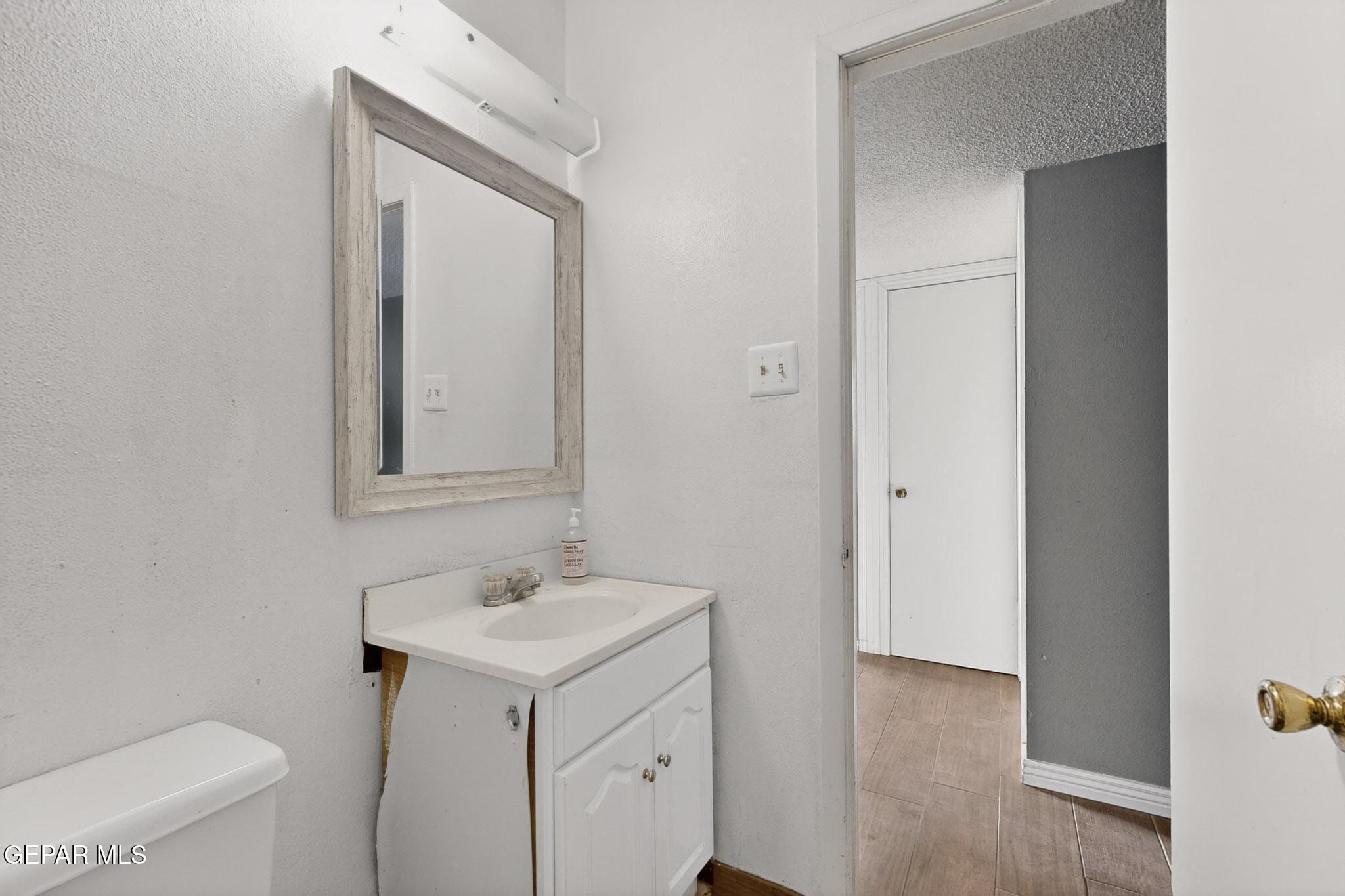 917 Marigold Way El Paso, TX 79907 - Photo 25 of 38 a bathroom with a sink toilet and mirror