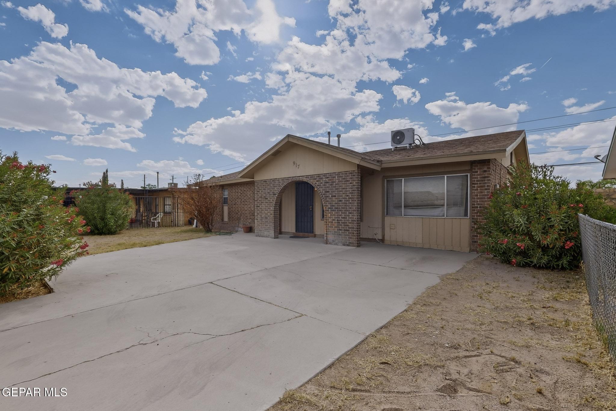 917 Marigold Way El Paso, TX 79907 - Photo 4 of 38 a yellow house with a yard and a large tree