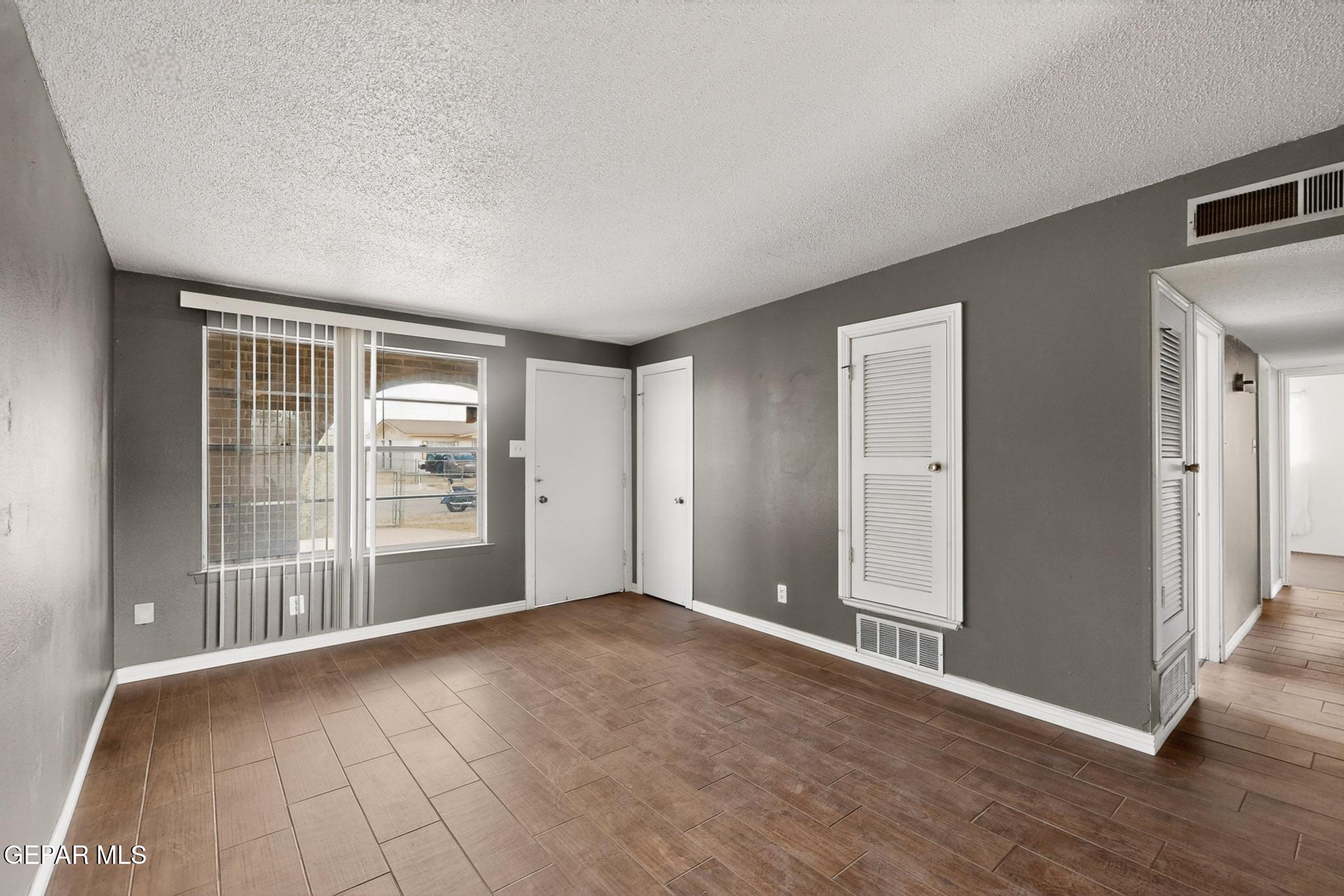 917 Marigold Way El Paso, TX 79907 - Photo 6 of 38 a view of an empty room with wooden floor and a window