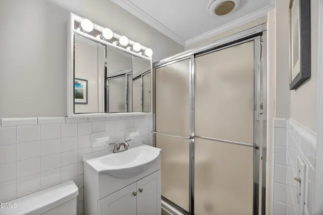 a bathroom with a sink and mirror with toilet