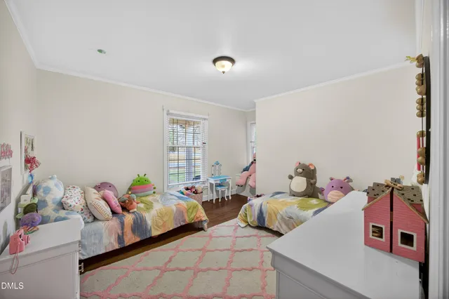 a bedroom with two beds and a window