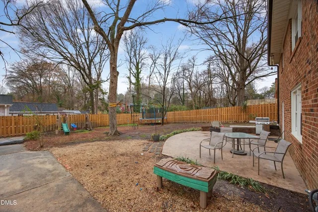 a view of a backyard with sitting area