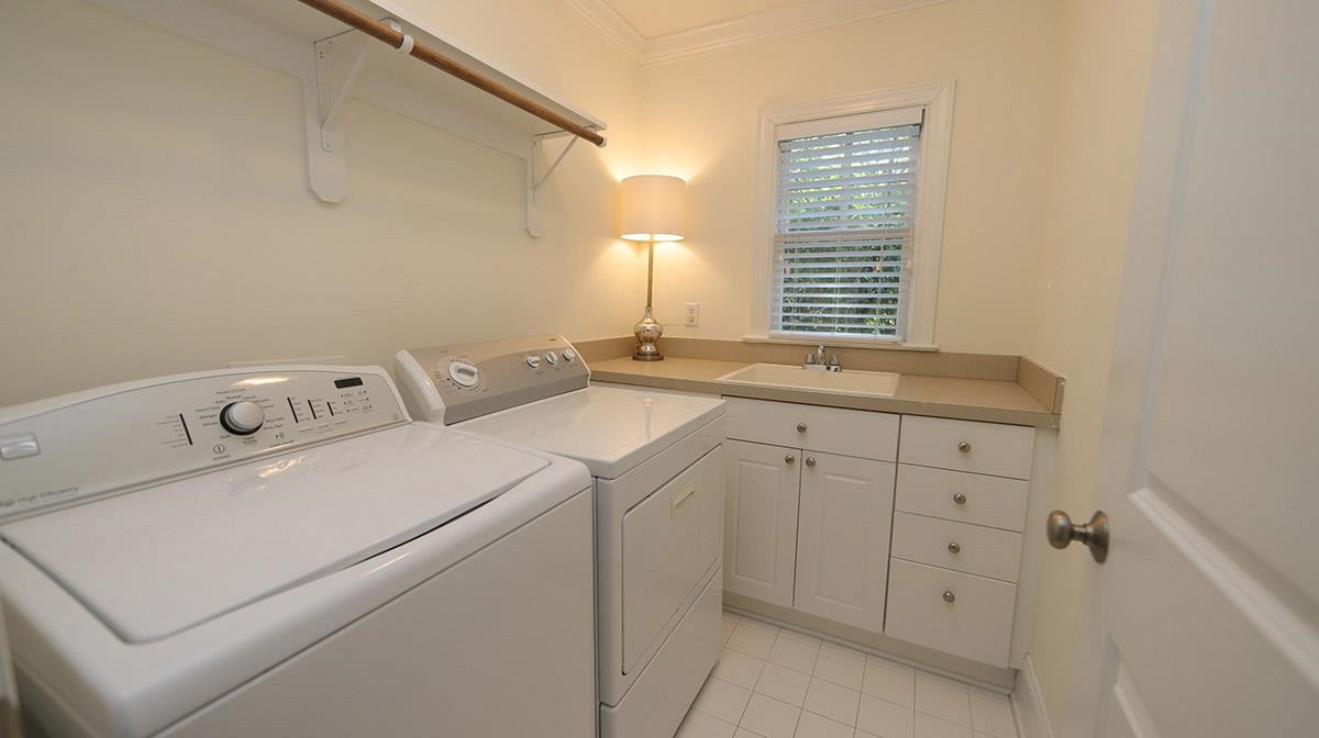 124 Village Mill Place Raleigh, NC 27608 - Photo 23 of 30 Laundry Room with a sink, counter space, cabinets and hanging rod. All you need. Laundry Room