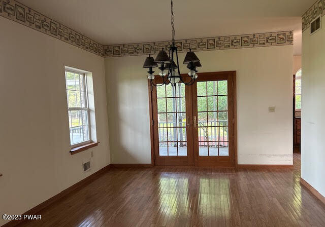 382 Roemerville Road Newfoundland, PA 18445 - Photo 3 of 25 a view of an empty room with wooden floor and a window