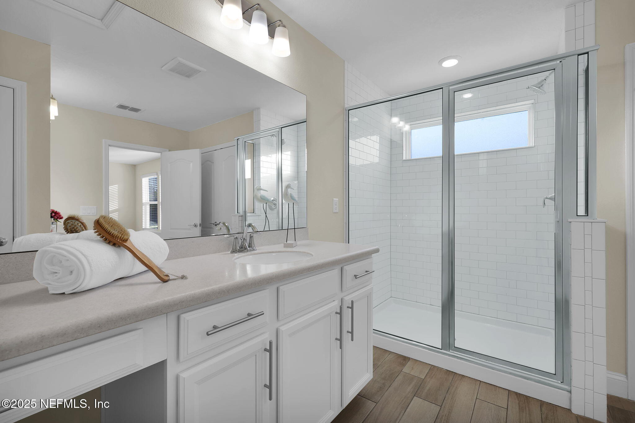 334 Clifton Bay Loop St. Johns, FL 32259 - Photo 24 of 60 a en suite bathroom with double vanity and a mirror