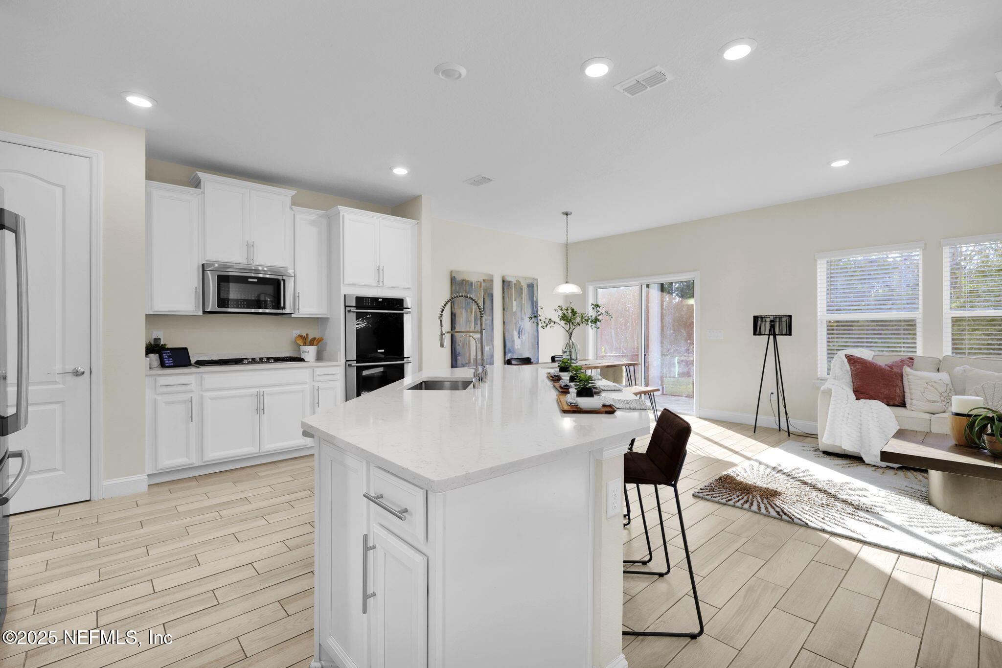 334 Clifton Bay Loop St. Johns, FL 32259 - Photo 3 of 60 a kitchen with a sink a counter top space stainless steel appliances and cabinets