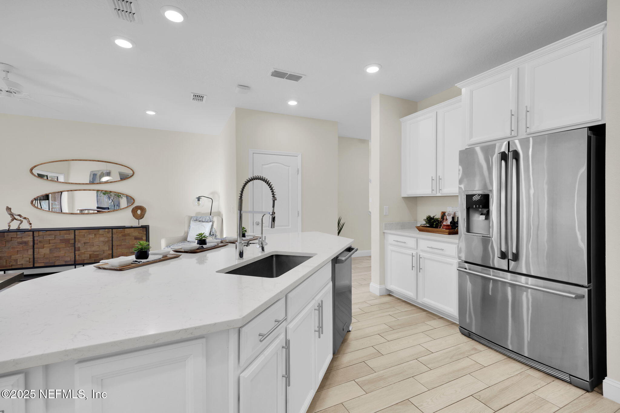 334 Clifton Bay Loop St. Johns, FL 32259 - Photo 9 of 60 a kitchen with white cabinets and stainless steel appliances