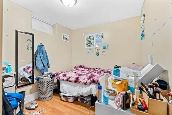 a bedroom with furniture and a wooden floor